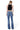 SaltTree model wearing Flying Monkey high rise medium blue bootcut jeans with a raw hem, viewed from the back.