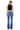 SaltTree Flying Monkey high rise bootcut jeans in medium blue wash with whiskering, worn by a model from the back.