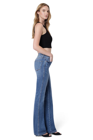 SaltTree model wearing Flying Monkey high rise medium blue bootcut jeans with a center front seam and raw hem.