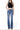 SaltTree model wearing Flying Monkey high rise bootcut jeans in medium blue wash with center front seams and raw hems.