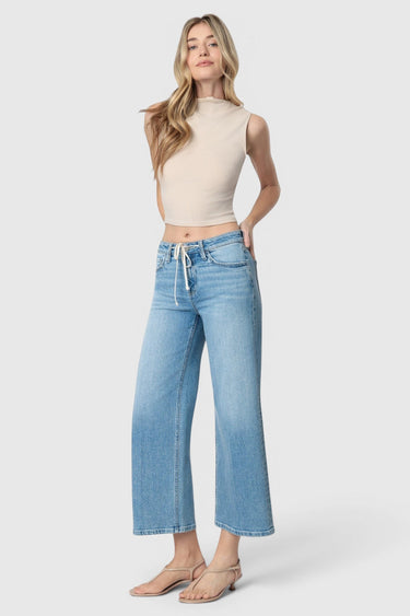 Model wearing SaltTree Flying Monkey medium wash high rise wide leg cropped jeans with a drawstring waist tie.