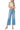 Model wearing SaltTree Flying Monkey medium wash high-rise drawstring wide-leg cropped jeans with a trouser crease.