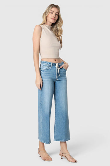 Model wearing SaltTree Flying Monkey medium wash high rise wide leg cropped jeans with a drawstring waist tie.