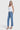 Model wearing SaltTree Flying Monkey medium dark wash high rise ankle straight jeans with a white tank top