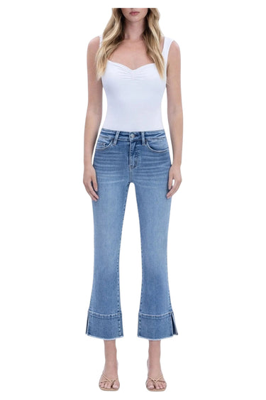SaltTree Flying Monkey high rise medium wash kick flare jeans with trouser slit hem worn by a model in a white top.