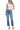 Model wearing SaltTree Flying Monkey super high rise ankle straight jeans in medium dark wash with distressed back hem