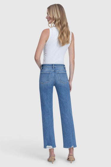 Model wearing SaltTree Flying Monkey medium dark wash high rise ankle straight jeans with distressed back hem
