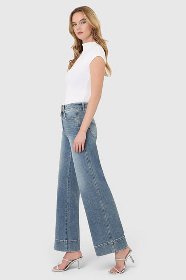 SaltTree model wearing Flying Monkey medium wash high rise wide leg jeans with a trouser hem and two-button closure.