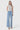 Model wearing SaltTree Flying Monkey high rise light wash wide leg jeans with cut seam detail and 31 inch inseam