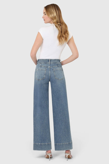 SaltTree model wearing Flying Monkey medium wash high rise wide leg jeans with a half yoke back and trouser hem.