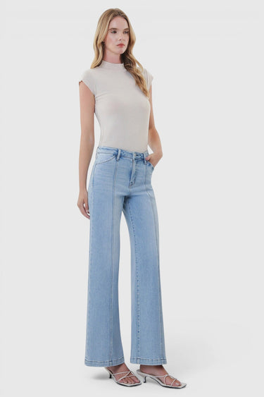 SaltTree model wearing Flying Monkey high rise light wash wide leg jeans with cut seam detail and heels