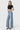 Model wearing SaltTree Flying Monkey mid rise light wash wide leg trouser jeans with a crease and 32 inch inseam