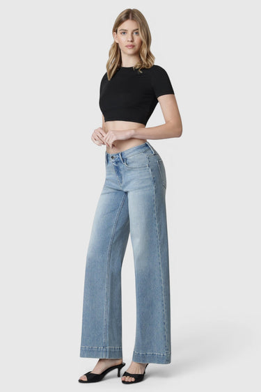 Model wearing SaltTree Flying Monkey mid rise light wash wide leg trouser jeans with a crease and 32 inch inseam