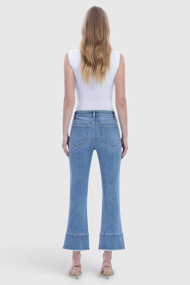 SaltTree Flying Monkey high rise kick flare jeans in medium wash with trouser slit hem, back view on a model.