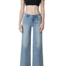 Model wearing SaltTree Flying Monkey mid rise wide leg jeans in light wash with a trouser crease and 32 inch inseam.