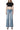 Model wearing SaltTree Flying Monkey mid rise wide leg jeans in light wash with a trouser crease and 32 inch inseam.