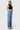 Model wearing SaltTree Flying Monkey high rise medium wash vintage flare jeans with slant side seams and raw hem.