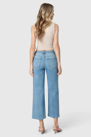Back view of a model wearing SaltTree Flying Monkey medium wash high rise wide leg cropped jeans with a drawstring
