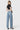 SaltTree model wearing Flying Monkey light wash mid-rise wide leg jeans with a trouser crease and 32-inch inseam.
