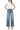 Model wearing SaltTree Flying Monkey medium wash super high rise wide leg jeans with a trouser hem and 2-button waist.