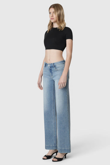 Model wearing SaltTree Flying Monkey mid rise wide leg jeans in light wash with trouser crease and 32 inch inseam