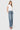 Model wearing SaltTree Flying Monkey medium wash super high rise wide leg jeans with a trouser hem and white top.