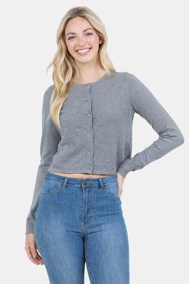 SaltTree model wearing a grey slim-fit cropped button-up cardigan by Dreamers with long sleeves and blue jeans.