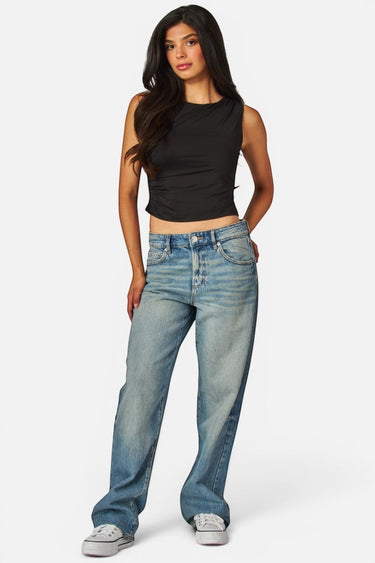 SaltTree Love Poem black sleeveless boatneck jersey top worn by a model with blue jeans and white sneakers