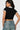 SaltTree Love Poem black cropped polo top with white contrast collar and sleeve cuffs worn with denim jeans