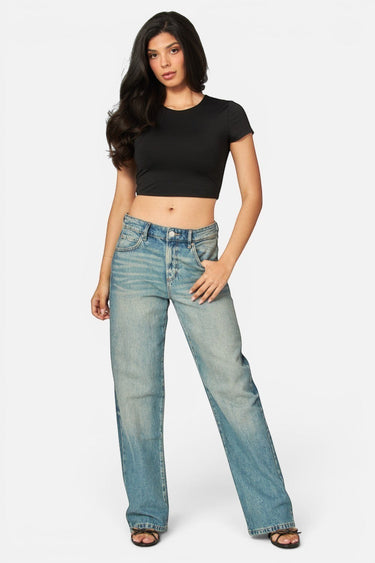 Model wearing a black SaltTree Love Poem cropped crew neck tee in smoothing double-layer fabric with blue jeans