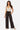 Model wearing SaltTree Love Poem black ribbed wide-leg pants with an elastic drawstring waist and side pockets.