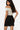SaltTree Love Poem black scuba mini skirt with side slit and faux-leather belt worn by a model in a white top