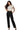 SaltTree Love Poem black high-rise straight-leg scuba knit pants with a belted waist worn by a model.