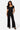 SaltTree Love Poem black scuba knit wide leg pants with belted waist worn by a model with a matching buttoned top