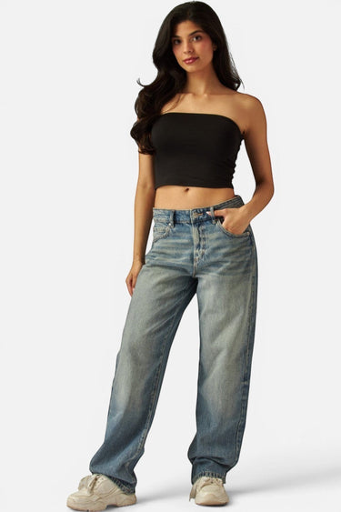 Model wearing a black SaltTree Love Poem double-layered strapless tube top with blue denim jeans