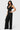 SaltTree Love Poem black waffle-knit two-piece set with a button-front vest and high-waisted wide-leg trousers.