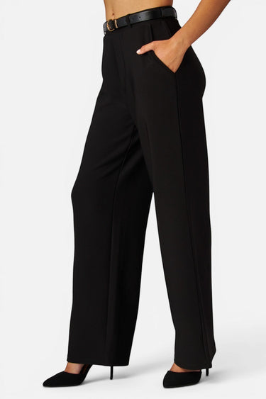 SaltTree Love Poem black high-rise wide-leg scuba knit pants with a belted waist and pockets worn by a model.