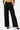 SaltTree Love Poem black high-rise wide-leg scuba knit pants with a belted waist and pockets on a model