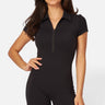 SaltTree Love Poem black zip-up polo romper in buttery-soft second-skin fabric worn by a smiling model.