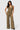 Model wearing SaltTree Love Poem green waffle-knit two-piece set with button-front vest and wide-leg drawstring pants