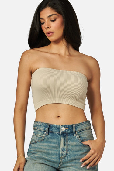 Model wearing a SaltTree Love Poem stone ribbed seamless strapless tube top with blue denim jeans.