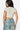 SaltTree Love Poem white double-layered cropped crewneck tee worn by a model with blue jeans, back view.