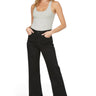 Model wearing SaltTree Mica Denim high rise wide leg cropped black jeans with a grey tank top and black heels