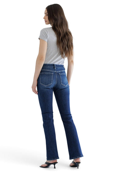 SaltTree Mica Denim mid-rise bootcut jeans in dark indigo with whiskering, worn by a model with a grey t-shirt.