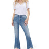 SaltTree model wearing Mica Denim high rise medium blue crop flare jeans with a frayed shark bite hem and booties.