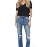 SaltTree model wearing Mica Denim high-rise straight jeans in vintage blue with distressed knees and raw side-slit hem.