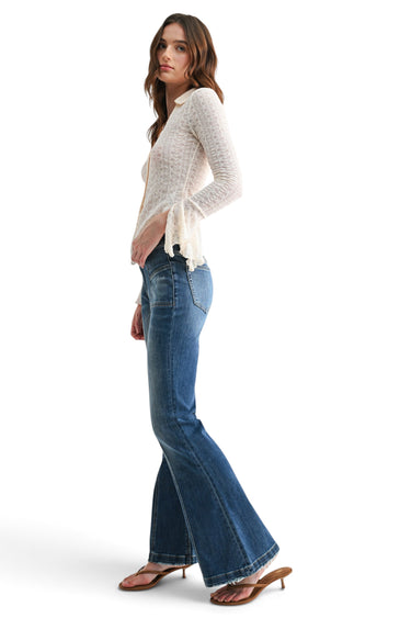 SaltTree model wearing Mica Denim high-rise flared jeans in vintage wash with front seam detail and 33-inch inseam.
