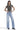 Model wearing SaltTree Mica Denim super high rise loose straight jeans in light blue wash with a grey t-shirt.
