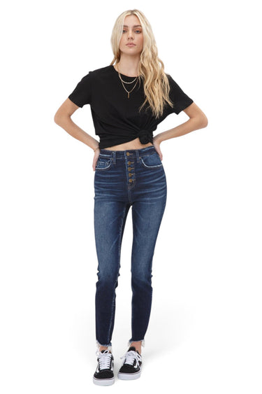SaltTree model wearing Mica Denim high rise skinny jeans in dark indigo with an exposed button fly and raw step hem.