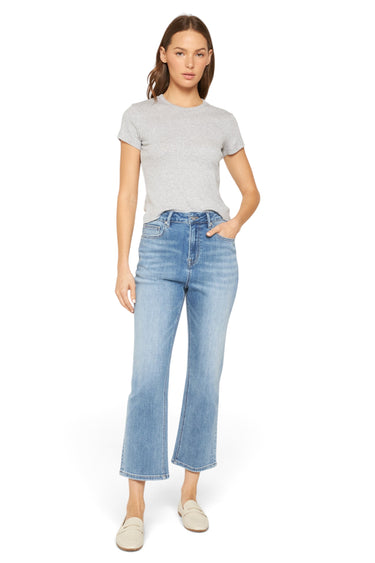 Model wearing SaltTree Mica Denim super high-rise straight loose fit jeans in medium blue with a grey t-shirt.